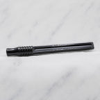 A close-up of SofTap pmu click stick handle, resting on a white marble surface.