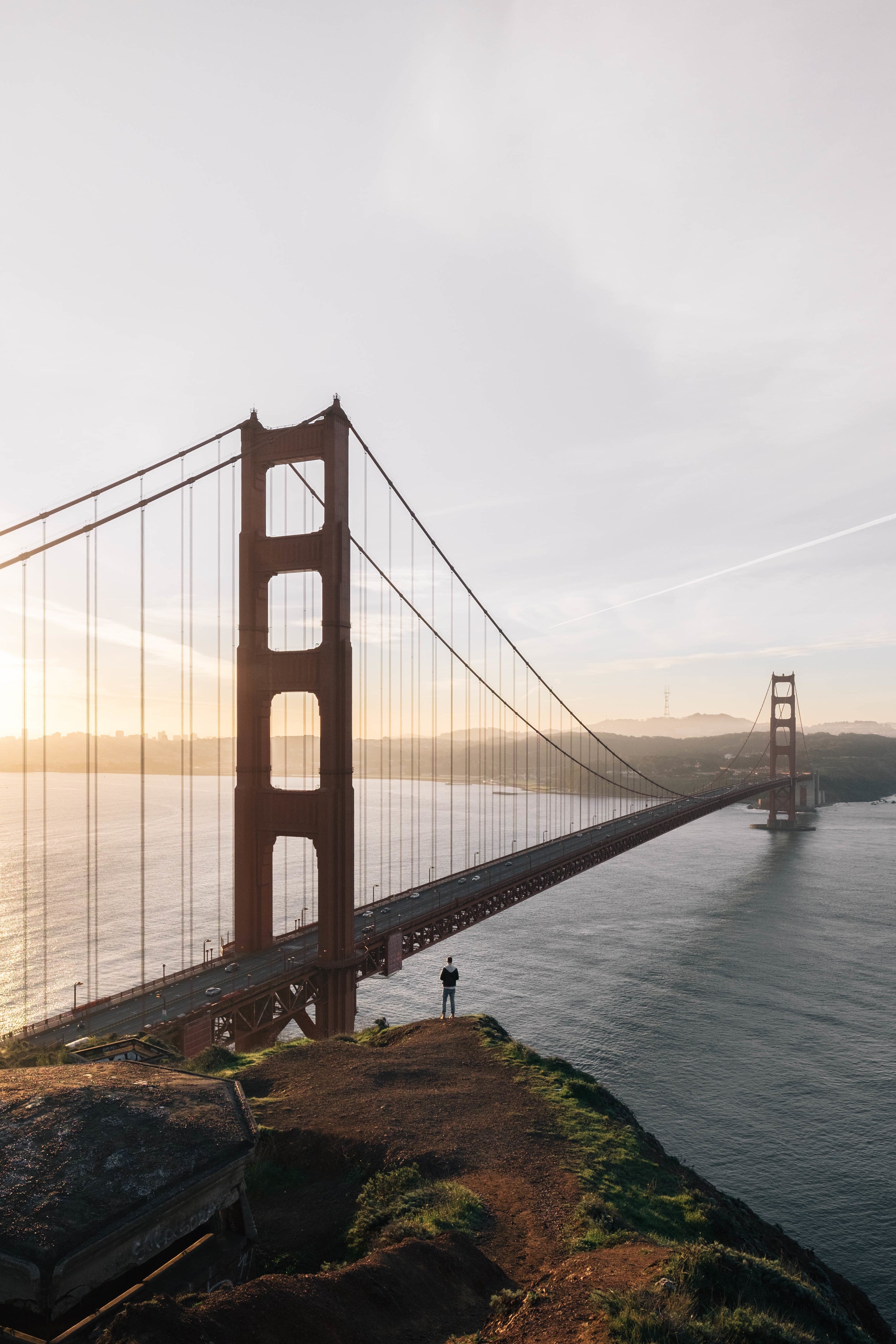 golden gate bridge with man hiking nearby