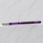 A close-up of SofTap small metal handle for foil cartridges, resting on a white marble surface.