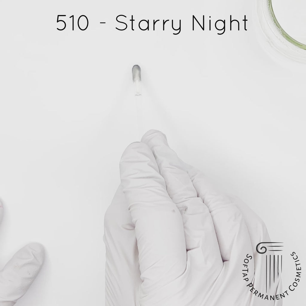 white gloved hand with white brush smearing SofTap black Starry Night Color for permanent eyeliner