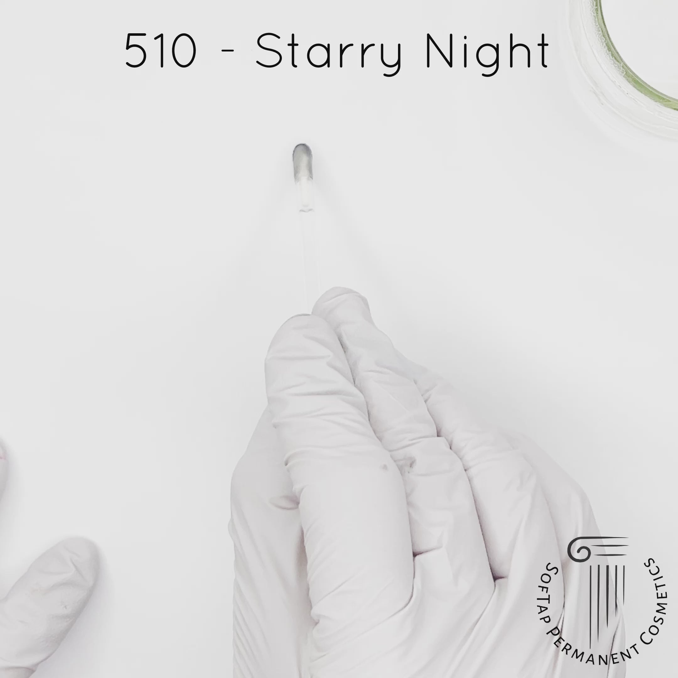 white gloved hand with white brush smearing SofTap black Starry Night Color for permanent eyeliner