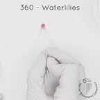 white gloved hand with white brush smearing SofTap pink Waterlilies Color for permanent lips