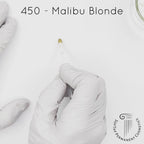 white gloved hand with white brush smearing SofTap light blonde Malibu Blonde Color for permanent eyebrows