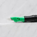 A close-up of SofTap 12 pmu needle click tip, resting on a white marble surface.
