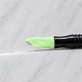 A close-up of SofTap 114 ultimate smudger pmu needle click tip, resting on a white marble surface.