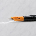 A close-up of SofTap 16 curve pmu needle click tip, resting on a white marble surface.