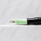 A close-up of SofTap 20 smudger pmu needle click tip, resting on a white marble surface.
