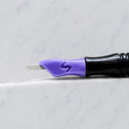 A close-up of SofTap 23 smudger pmu needle click tip, resting on a white marble surface.