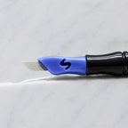 A close-up of SofTap 28 pmu needle click tip, resting on a white marble surface.
