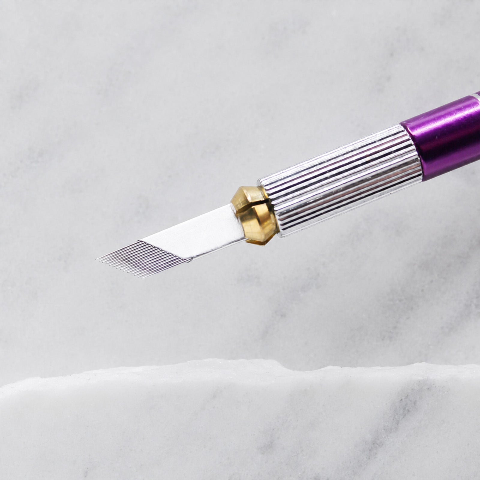 A close-up of SofTap 28 pmu needle foil cartridge, resting on a white marble surface.