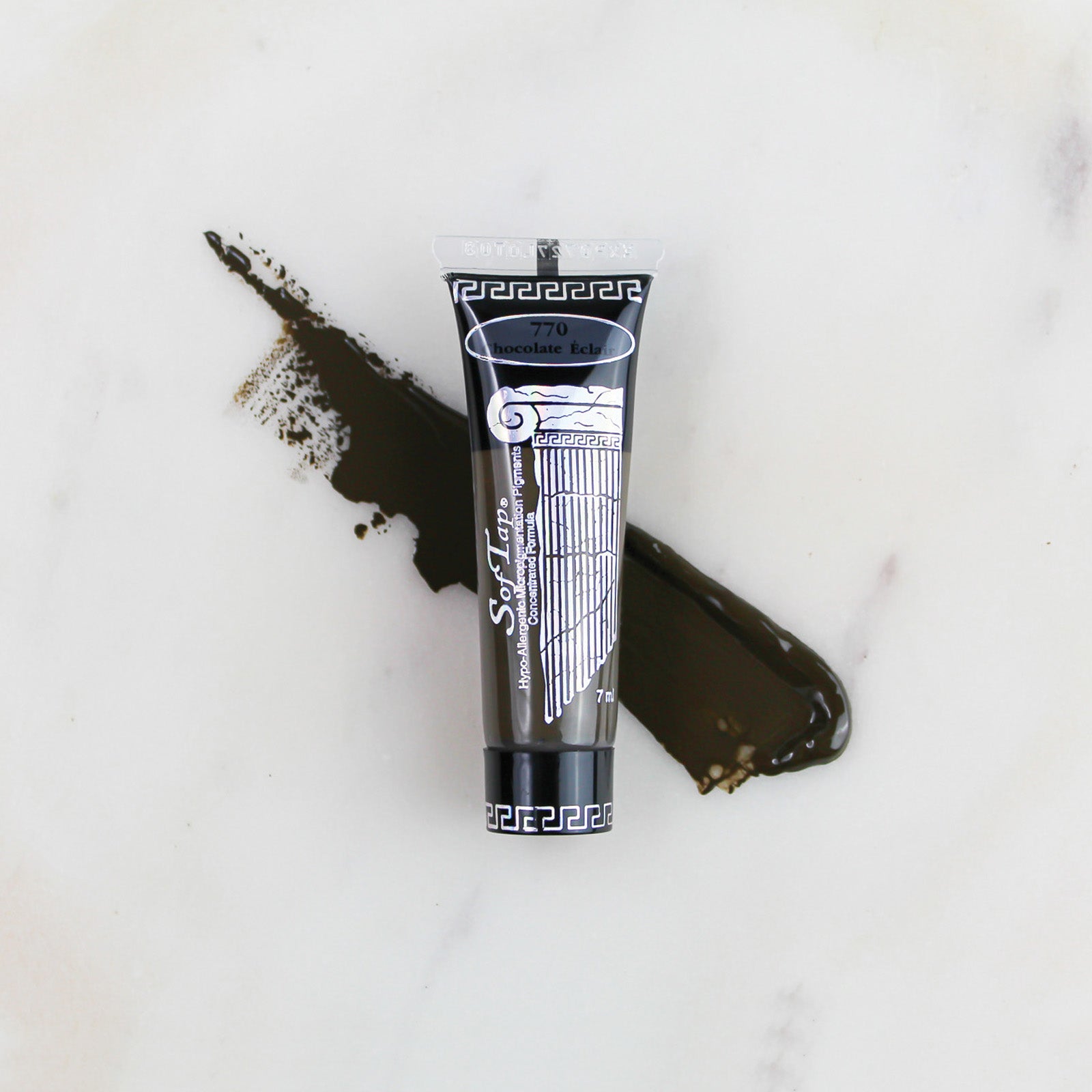 SofTap permanent makeup pigment Chocolate Eclair tube with color swatch on marble background