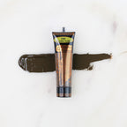 SofTap permanent makeup pigment Chocolate Truffle tube with color swatch on marble background