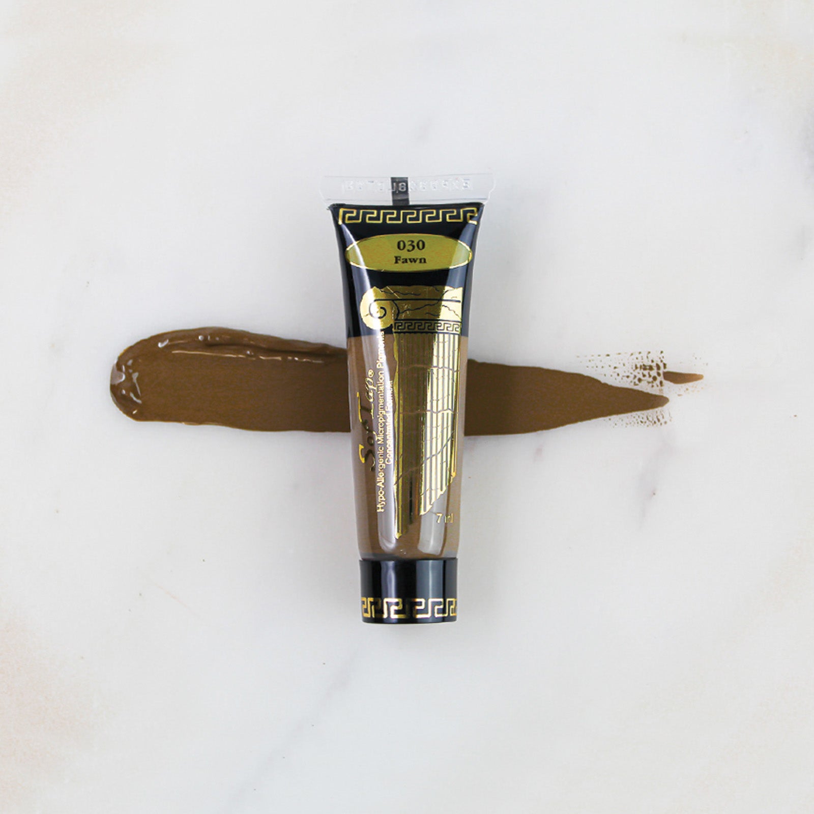 SofTap permanent makeup pigment Fawn tube with color swatch on marble background