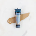SofTap permanent makeup pigment Golden Sunrise tube with color swatch on marble background