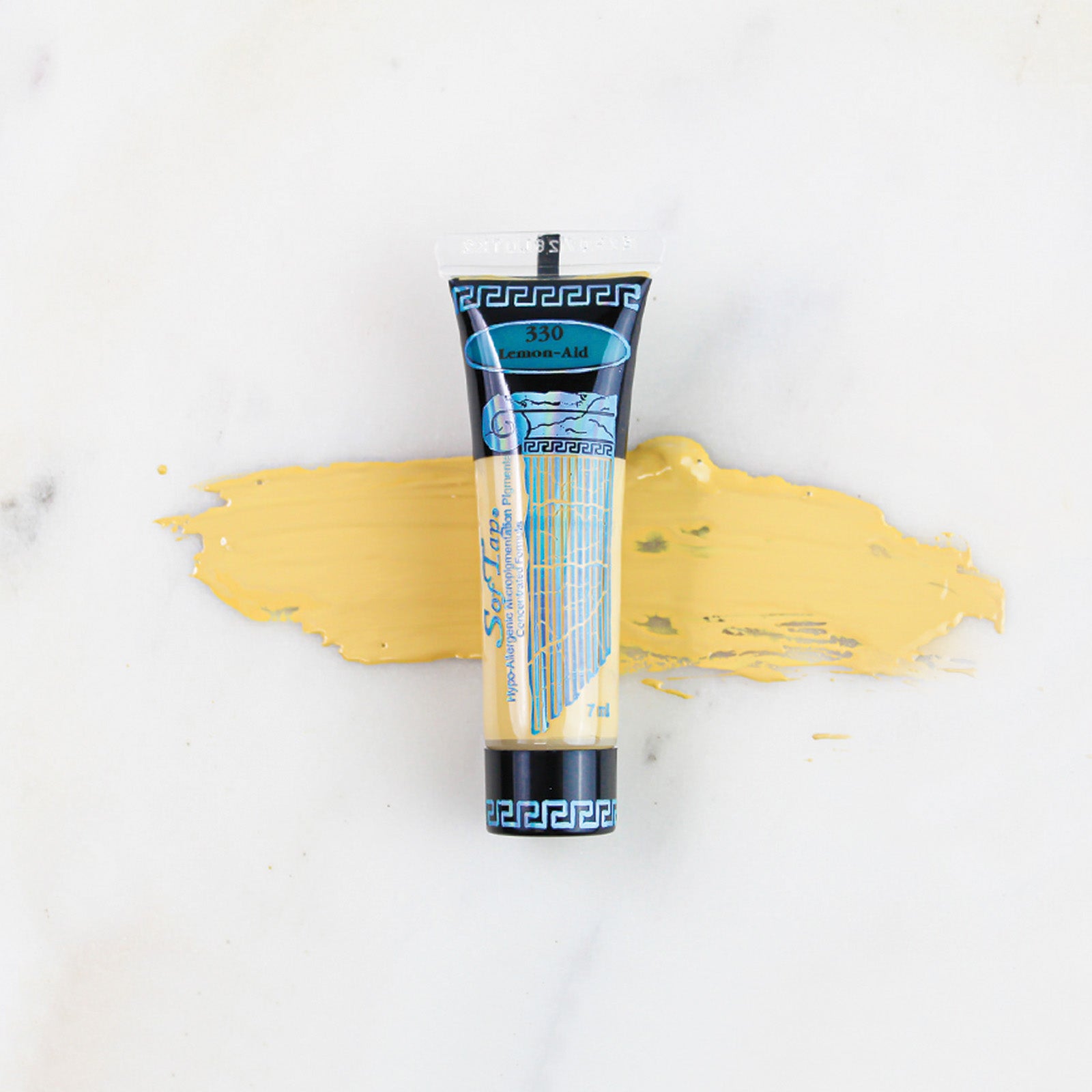SofTap permanent makeup pigment Lemon-Aid tube with color swatch on marble background