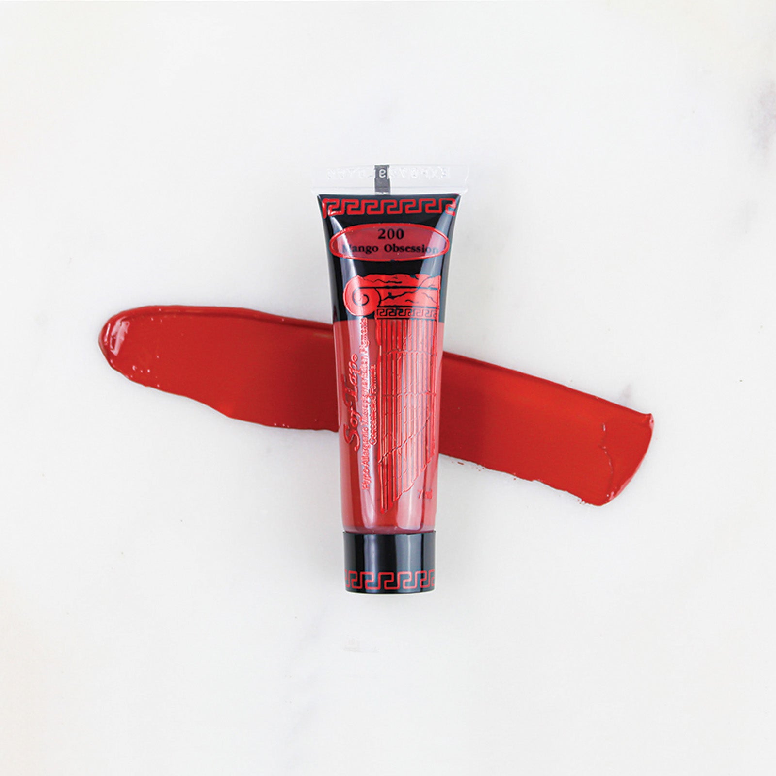 SofTap permanent makeup pigment Mango Obsession tube with color swatch on marble background