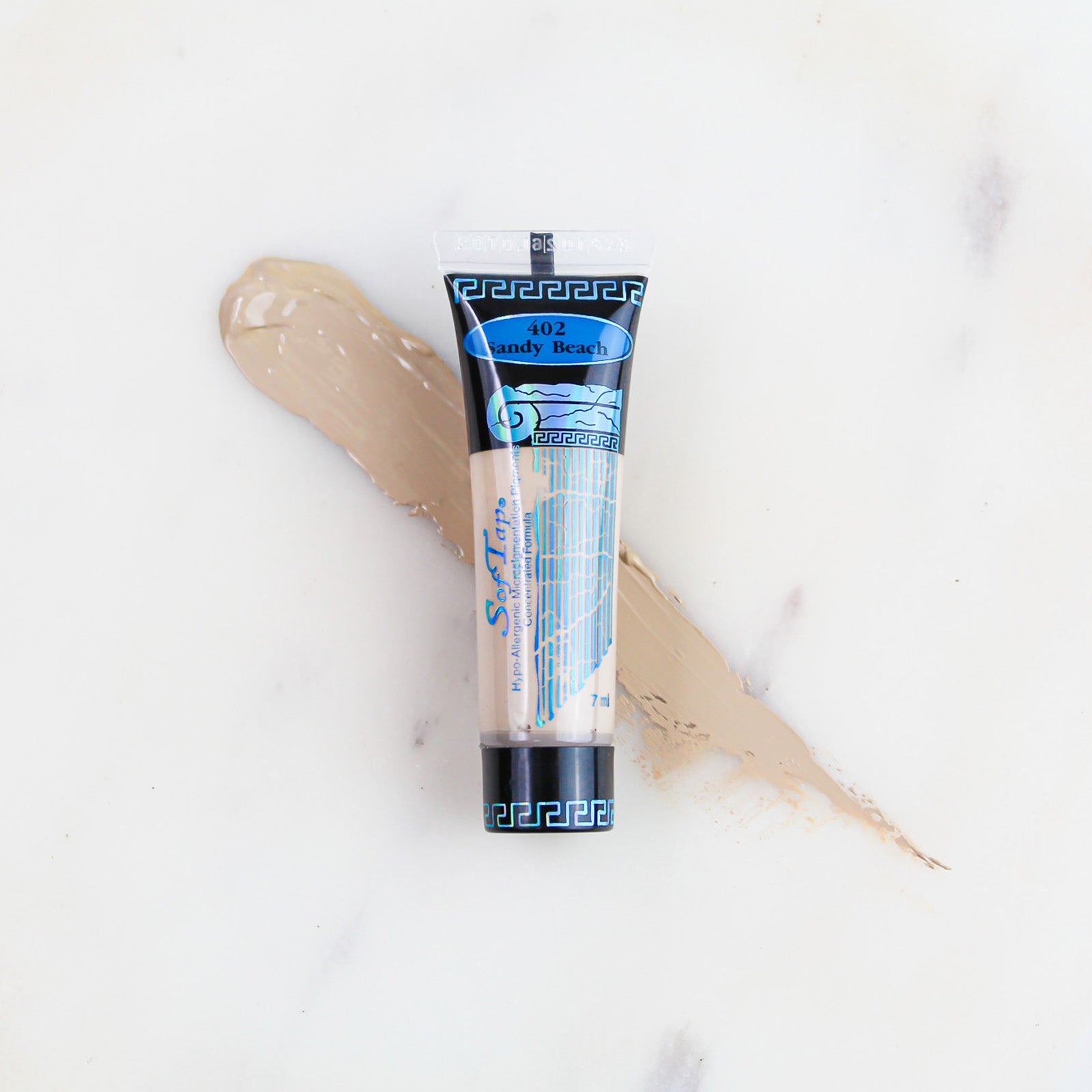 SofTap permanent makeup pigment Sandy Beach tube with color swatch on marble background